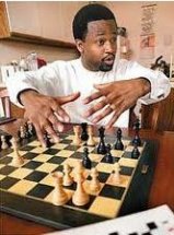 Maurice Ashley explicando algo en un tablero de ajedrez